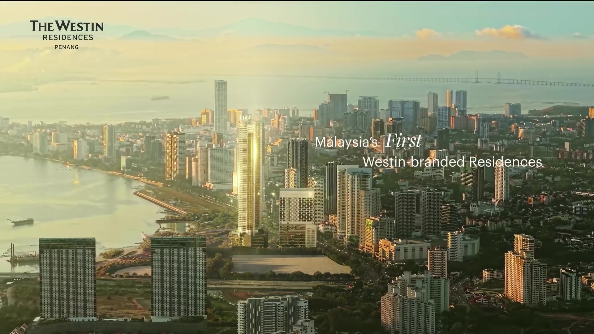 Gurney Drive Seafront Residences tower rising above the Penang skyline over Gurney Bay at golden hour