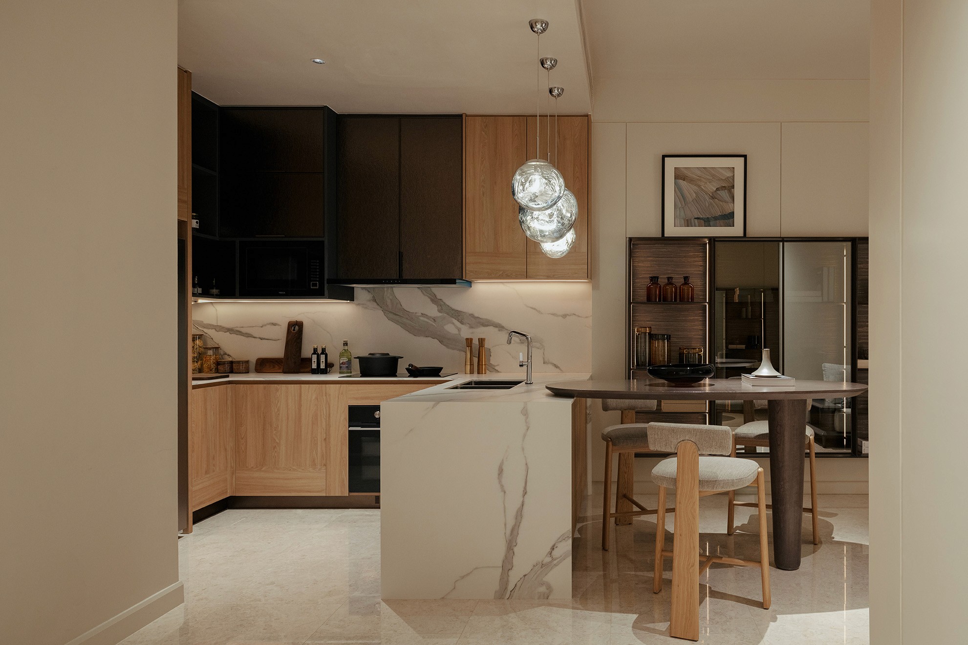 Kitchen with marble island, breakfast bar and timber cabinetry — Gurney Drive Seafront Residences show unit