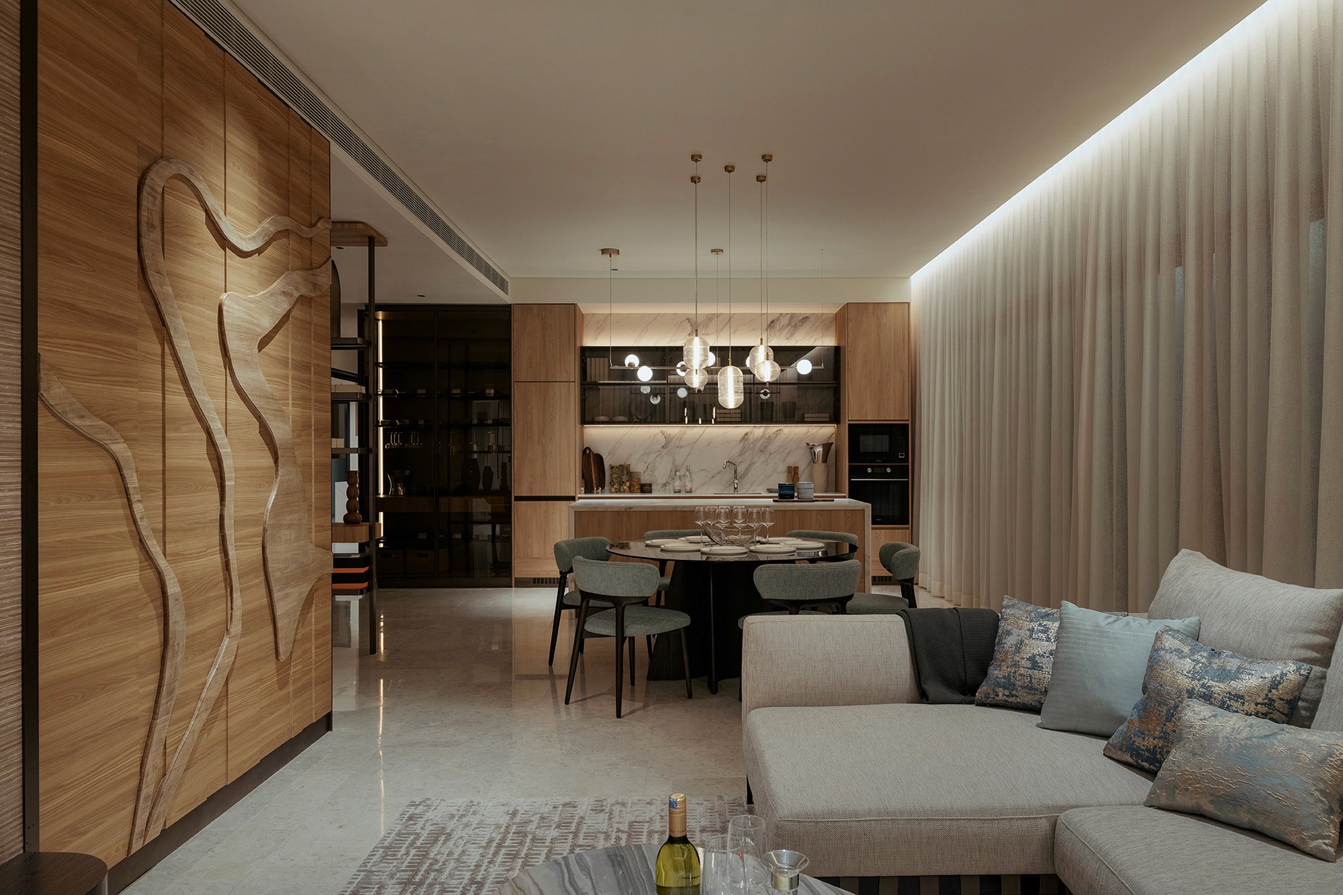 Open-plan living and dining space with sculpted timber feature wall — Gurney Drive Seafront Residences show unit