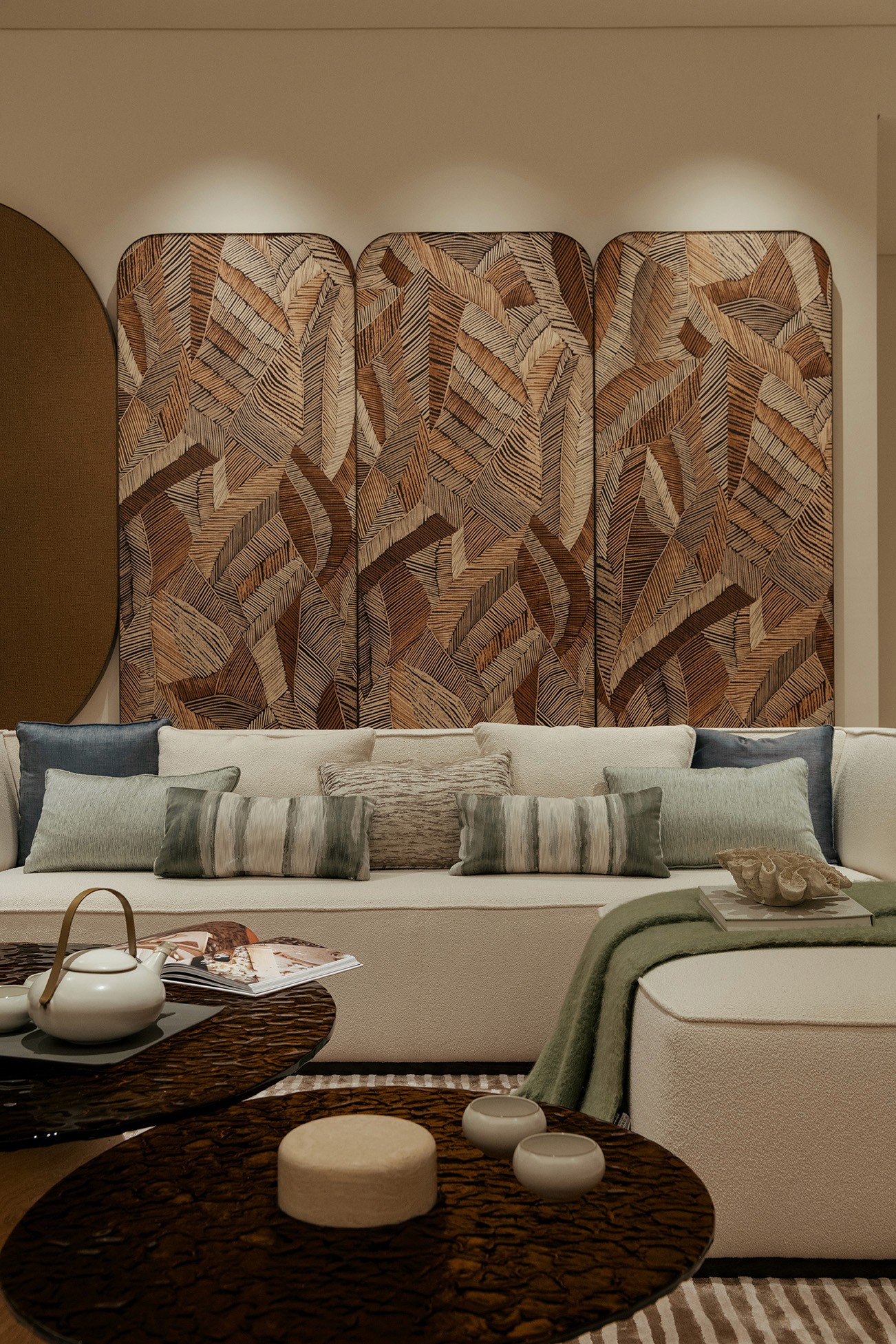 Lounge corner with carved timber panelling and boucle sofa — Gurney Drive Seafront Residences show unit