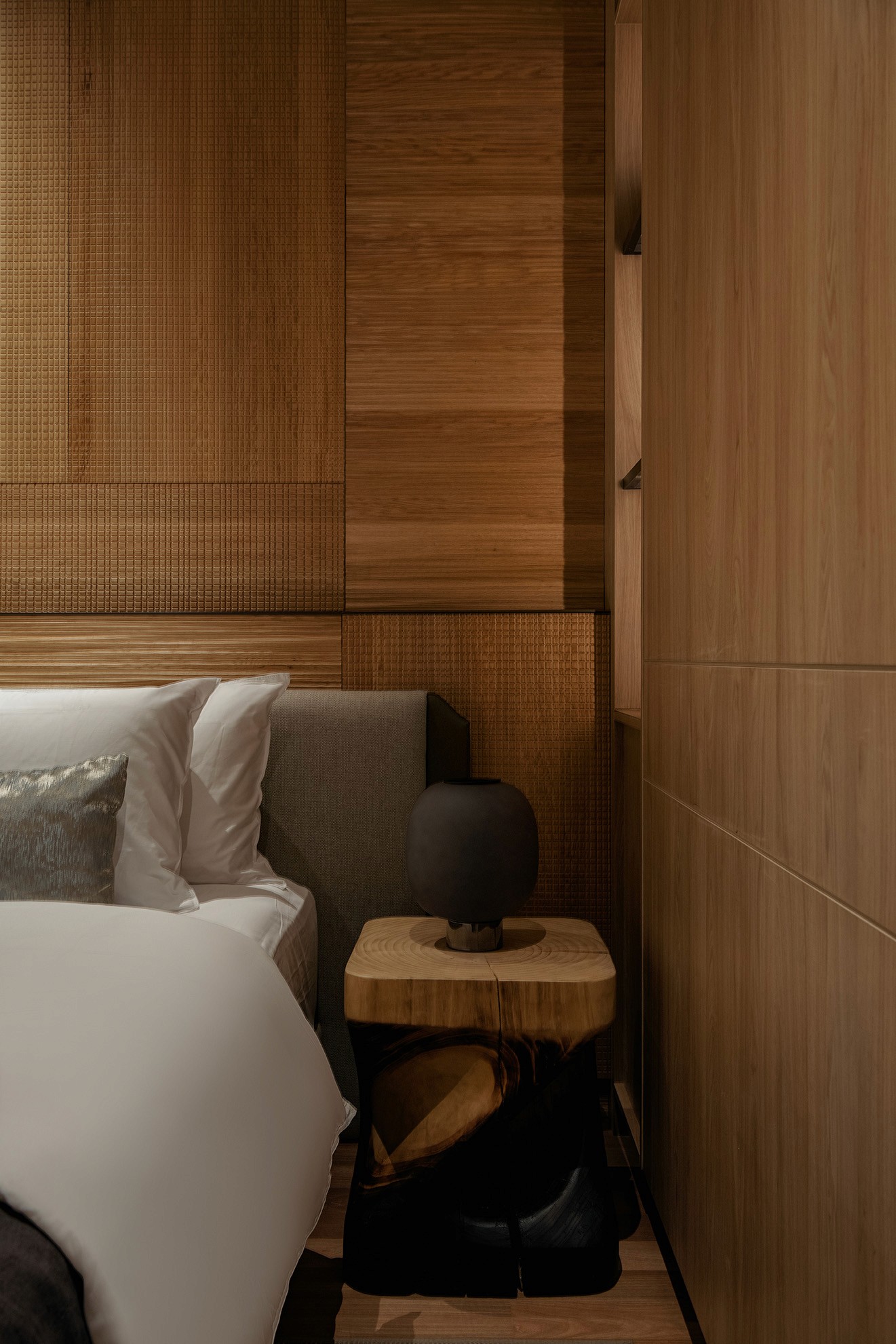 Master bedroom with upholstered headboard and timber-clad walls — Gurney Drive Seafront Residences show unit